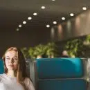 woman sitting on gray and blue gang chair