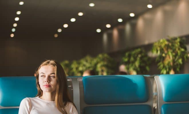 woman sitting on gray and blue gang chair